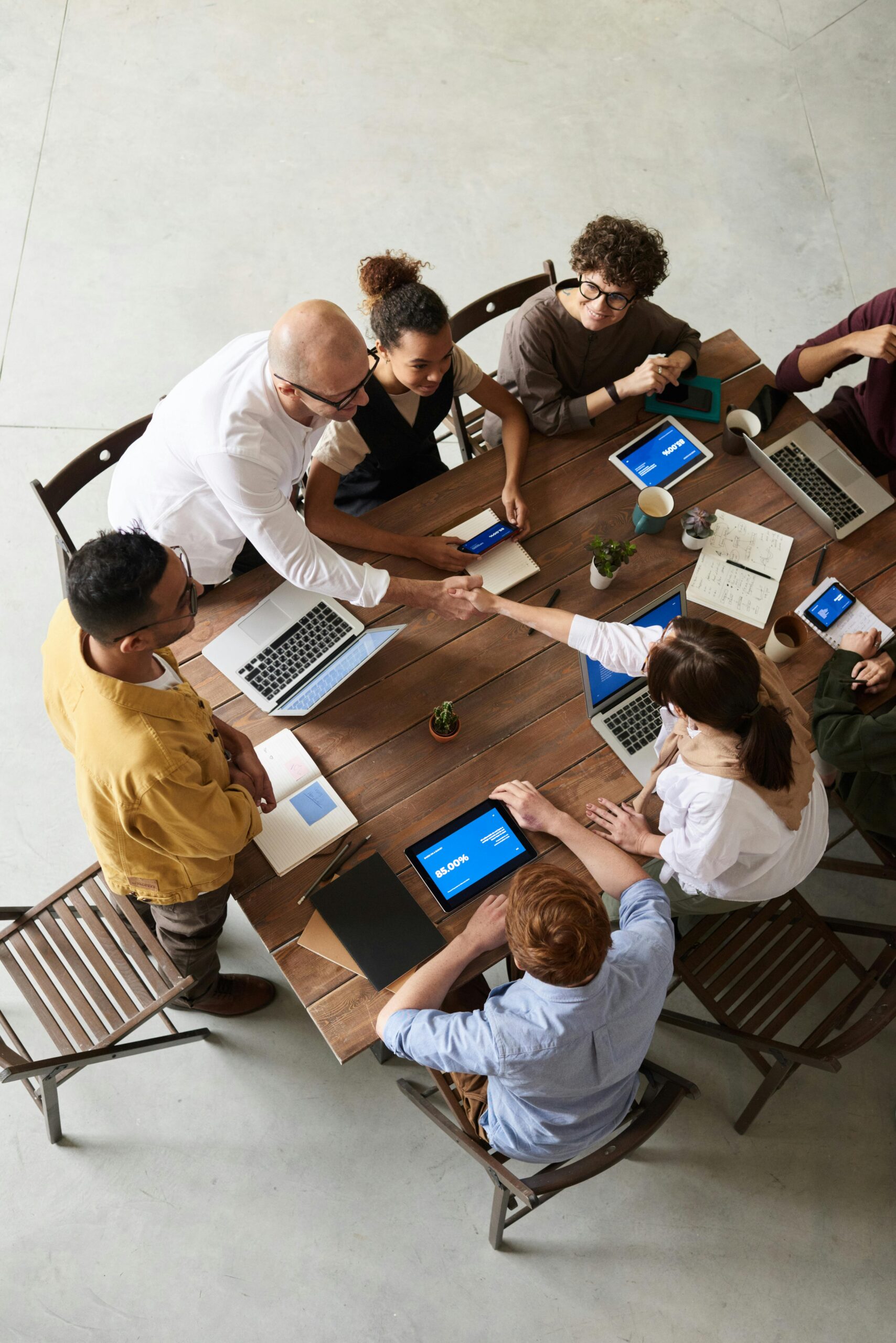 Overhead shot of a diverse team collaborating in a modern office meeting.